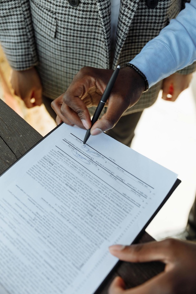 Two people signing a contract